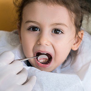 Small girl receiving dental exam