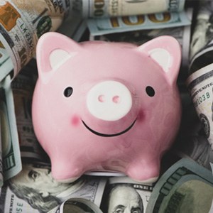 Piggy bank on pile of money