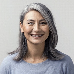 Smiling woman with dental implants in Alhambra