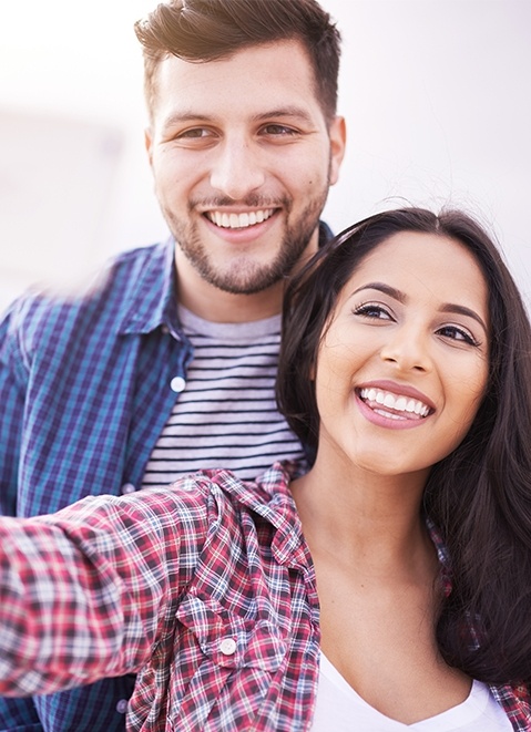 Man and woman smiling outdoors