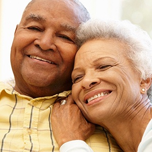 smiling couple with dental implants in Alhambra