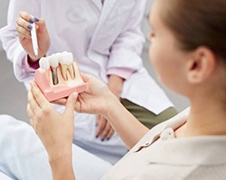 Alhambra implant dentist explaining dental implants with model