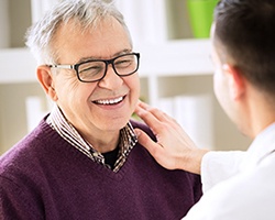 Man smiles while talking to his Alhambra implant dentist