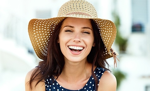 Laughing woman with sun hat
