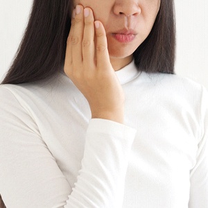 Woman with TMD, may benefit from Invisalign treatment
