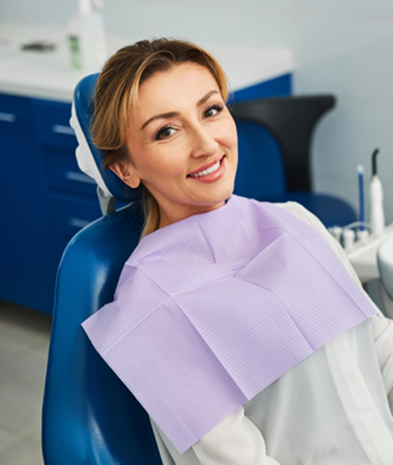 Woman smiling while sitting in treatment chair